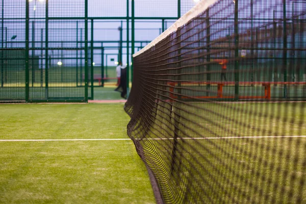 Paddle tennis net at night