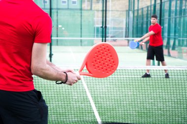 friends playing paddle tennis