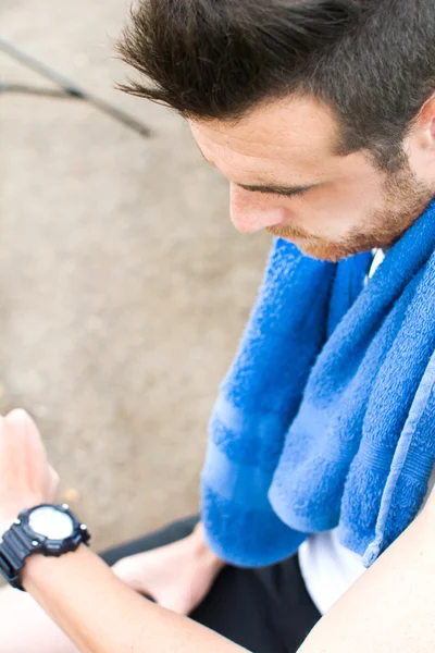 Man doing running and watching the watch in park — Stock Photo, Image