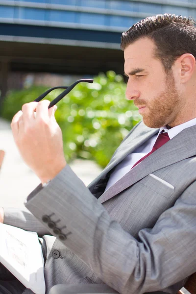 Businessman reading a newspaper outside — Stock Photo, Image