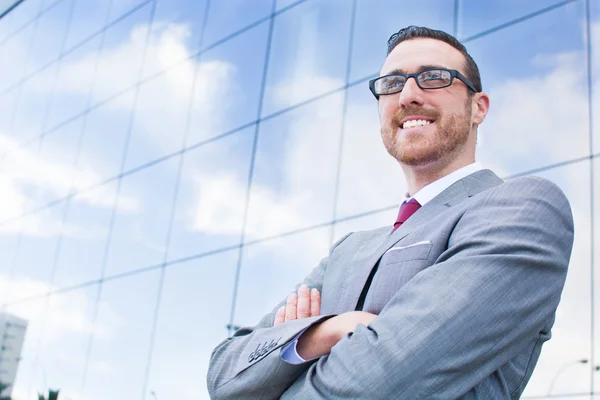 Businessman smiling with folded hands — Stock Photo, Image