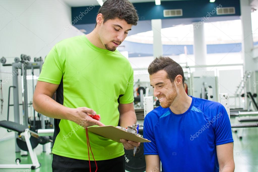 young man with personal trainer at the gym of the University of Las Palmas de Gran Canaria