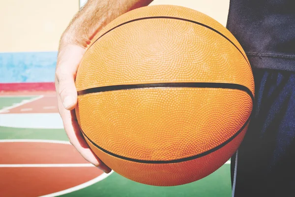 Jovem com uma bola de basquete — Fotografia de Stock