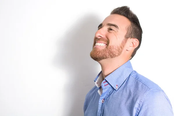 Man smiling with white wall with shadow — Stock Photo, Image