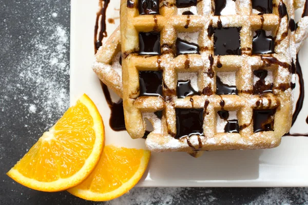 Waffles with chocolate and oranges — Stock Photo, Image