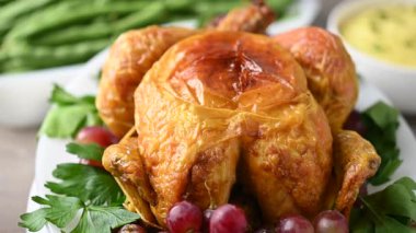 Thanksgiving dinner on rustic wooden table with roasted turkey,mashed potatoes,ears of corn and green bean casserole