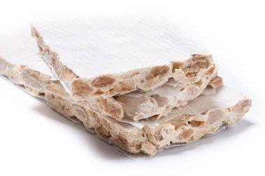 Delicious almond nougat isolated on white background. Traditional Christmas sweet
