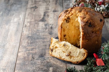 Traditional Italian Panettone on wooden table. Copy space
