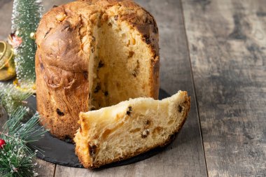 Traditional Italian Panettone on wooden table. Copy space