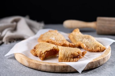 Gri taşlı arka planda ev yapımı tatlı balkabağı empanadillası