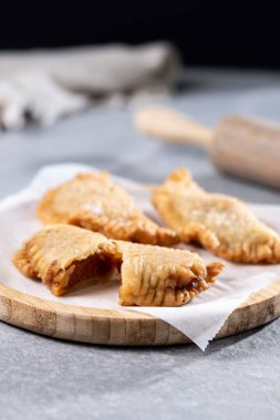 Gri taşlı arka planda ev yapımı tatlı balkabağı empanadillası