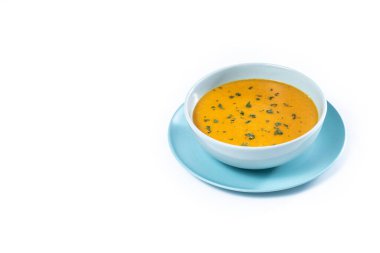 Mavi Kasedeki Kremalı Havuç Çorbası beyaz arka planda izole edilmiş. Boşluğu kopyala