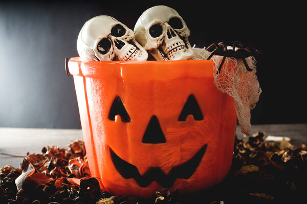 Halloween lollipops and candies inside a basket with pumpkin shape