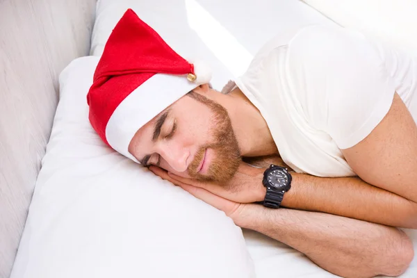Man with santa hat  sleeping in bed — Stock Photo, Image