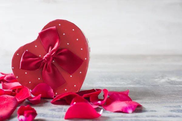 Gift box with heart shape and petals — Stock Photo, Image