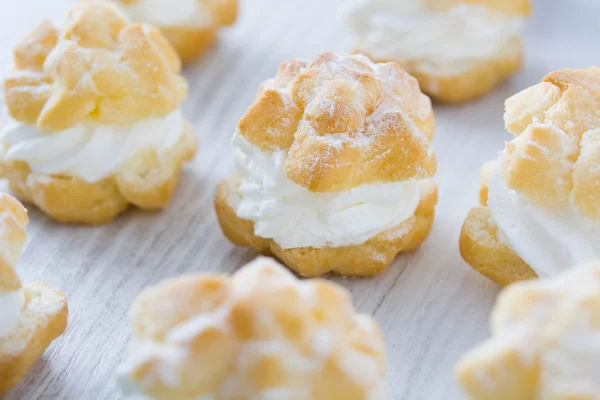 Fresh profiteroles with cream — Stock Photo, Image