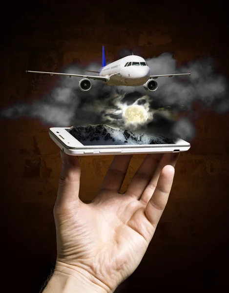 Flying plane on a background of mountains from the smartphone sc — Stock Photo, Image