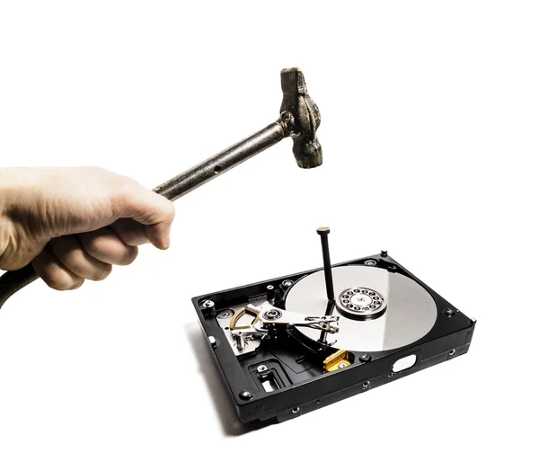 A hammer hits a nail into the hard drive from the computer — Stock Photo, Image