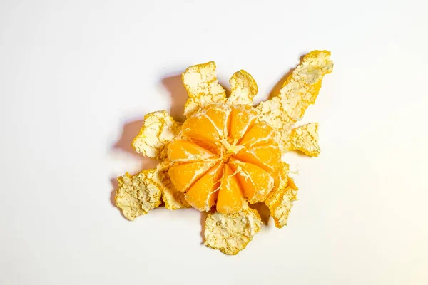 Orange peeled tangerine with peel on white background .Top view