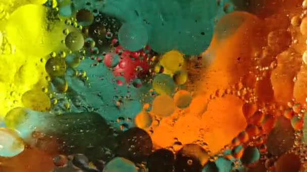 Chaotically moving multicolored bubbles in a viscous liquid substance. — Stock Video