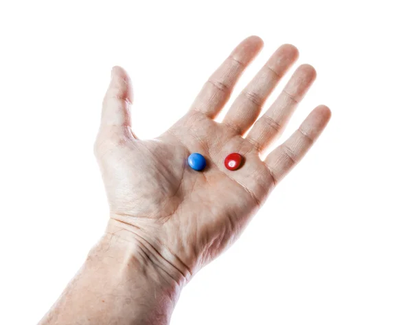 Red and blue pills on hand isolated — Stock Photo, Image