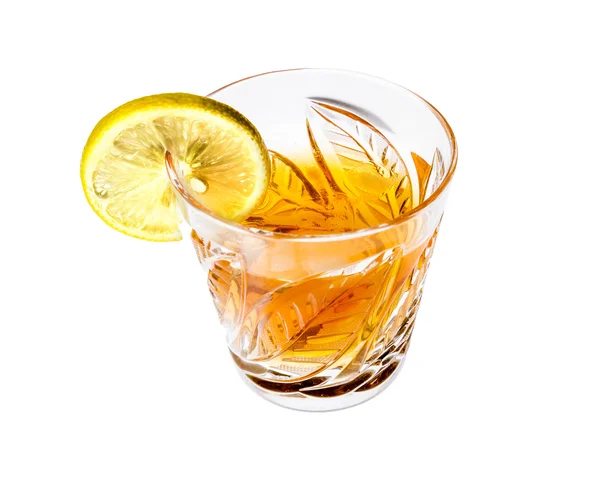 Crystal glass with alcohol and a slice of lemon — Stock Photo, Image