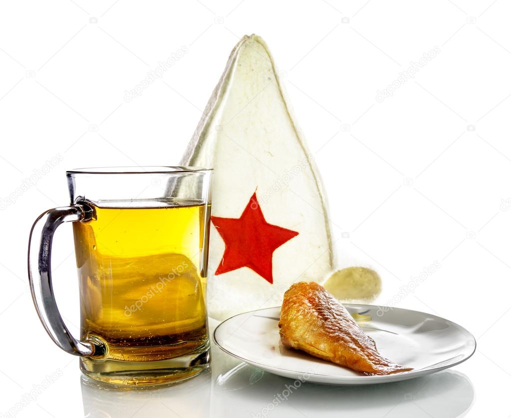 Mug with beer and fish on a plate and a bathing cap with red sta