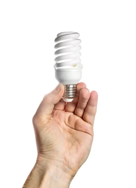 Una lampada a risparmio energetico in una mano maschile su sfondo bianco — Foto Stock