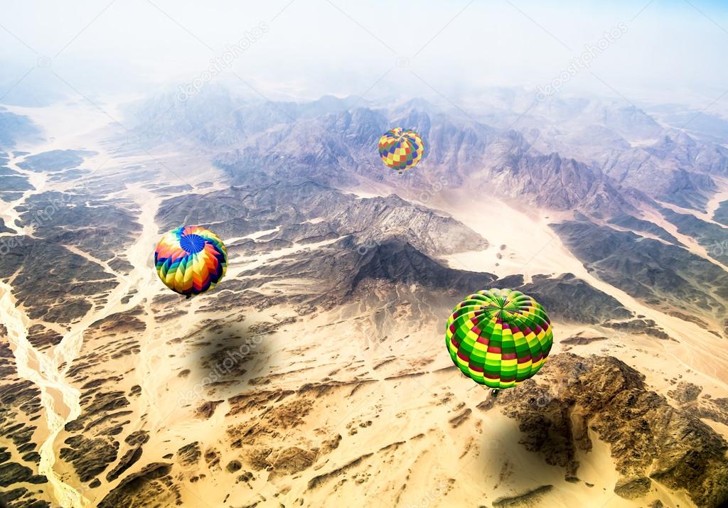 View from the heights of flying over mountains hot air balloons