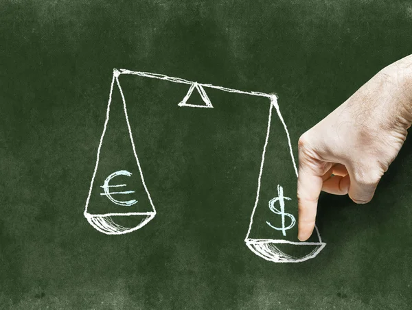 The dollar and the euro on the scales drawn on the Blackboard wi — Stock Photo, Image