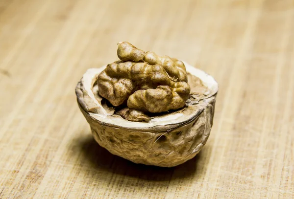 Chopped Walnut rests on a wooden  board — Stock Photo, Image