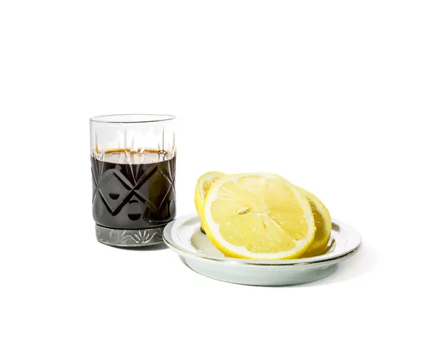 Shot glass with alcohol and lemon on a saucer — 스톡 사진