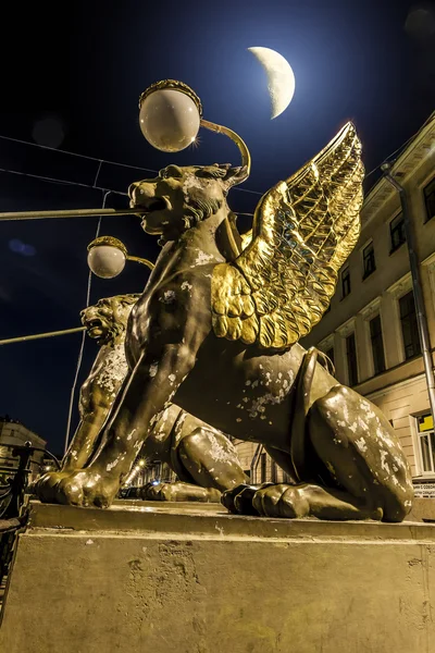 Griffins on Bank bridge across the griboyedov Canal in Moonlight