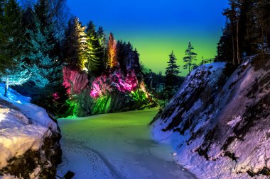 Polar lights over marble quarry Ruskeala in Karelia in winter. clipart