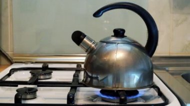 Bir gaz sobası mutfakta bir ıslık ile bir kazana su kaynar