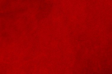 Süet kumaşın kırmızı mat arka planı, yakın plan. Pürüzsüz deri kadife desenli. Keçeleşmiş makro. Kırmızı süet kumaş. Kumaş, deri, tasarımcılar için malzeme..