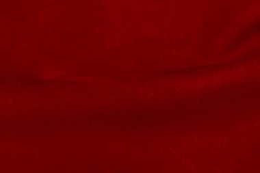 Süet kumaşın kırmızı mat arka planı, yakın plan. Pürüzsüz deri kadife desenli. Keçeleşmiş makro. Kırmızı süet kumaş. Kumaş, deri, tasarımcılar için malzeme..