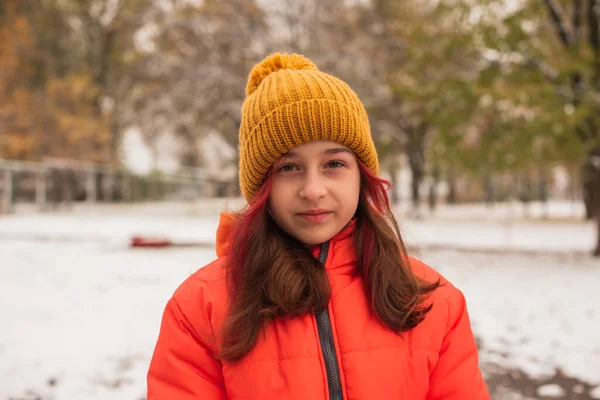 穿着鲜艳橙色保暖夹克的女孩 下雪天穿橙色夹克的女孩 冬天的少女 — 图库照片