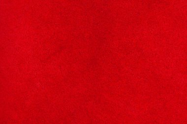 Süet kumaşın kırmızı mat arka planı, yakın plan. Pürüzsüz deri kadife desenli. Keçeli kumaş