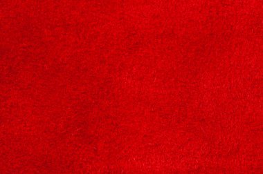 Süet kumaşın kırmızı mat arka planı, yakın plan. Pürüzsüz deri kadife desenli. Keçeli kumaş