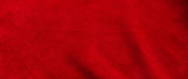 Süet kumaşın kırmızı mat arka planı, yakın plan. Pürüzsüz deri kadife desenli. Keçeli kumaş