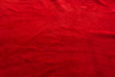 Süet kumaşın kırmızı mat arka planı, yakın plan. Pürüzsüz deri kadife desenli. Keçeli kumaş