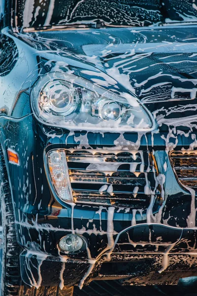 washing the car. Washing a black car at a car wash. Clean car