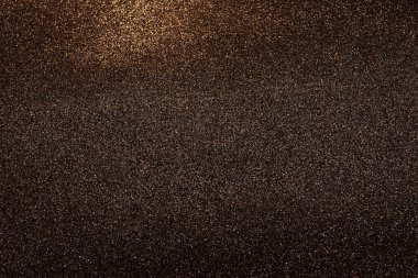 Bronz ve siyah Bokeh soyut ışık arkaplanı. Şenlikli Noel tasarım unsuru. Parılda.