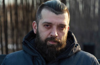 Sokakta gri ceketli sakallı bir adam. Bir adamın portresi. Sakallı adam..