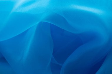 Arkaplan olarak kullanılan açık mavi doku. Mavi açık renk kumaş dokusu. Mavi organza kumaş
