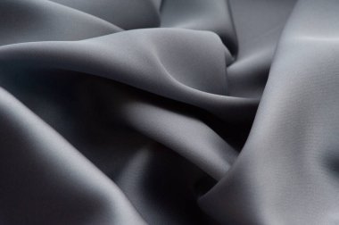 Gri ipek kumaş. Bu saten kumaş kumaş kumaş kumaş, arka plan ve desen yapmak için mükemmel. gri