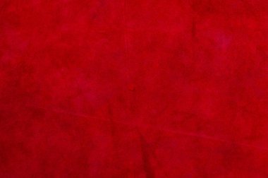 Pürüzsüz deri kadife desenli. Keçeleşmiş makro. Kırmızı süet kumaş. Kumaş, deri