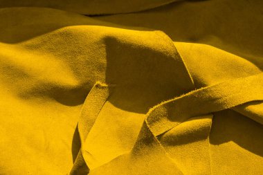 Pürüzsüz deri kadife desenli. Keçeleşmiş makro. Sarı süet kumaş. deri