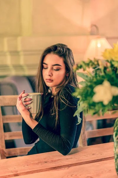 Beautiful Woman With Cup of Tea or Coffee. Girl with a cup looking down. cafe, girl, coffee,